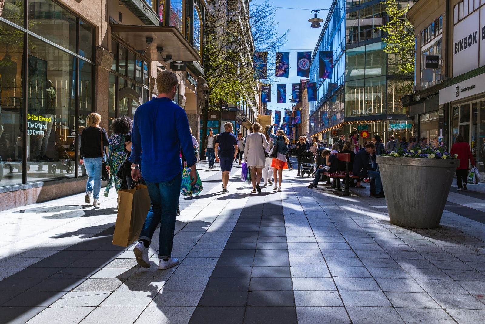 people walking in between buildings during daytime